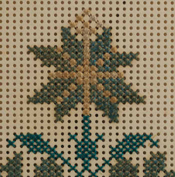 Detail of the flower and leaves in the embroidery sampler.