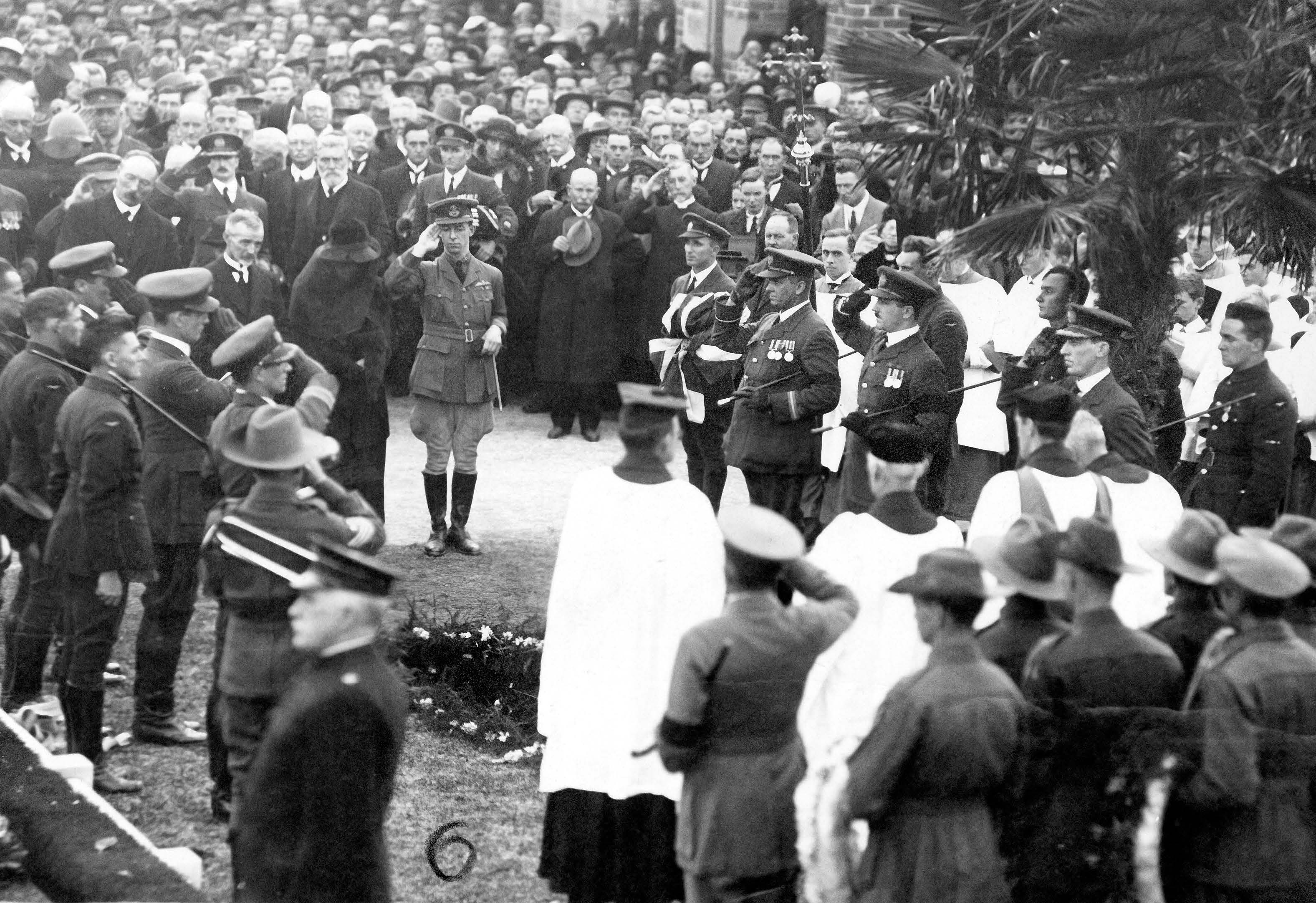 Andrew and Jessie and Keith Smith stand as the last post is sounded at the burial plot at North Road Cemetery. Pipers played a lament in honour of Ross’ Scottish heritage. SLSA: B 899