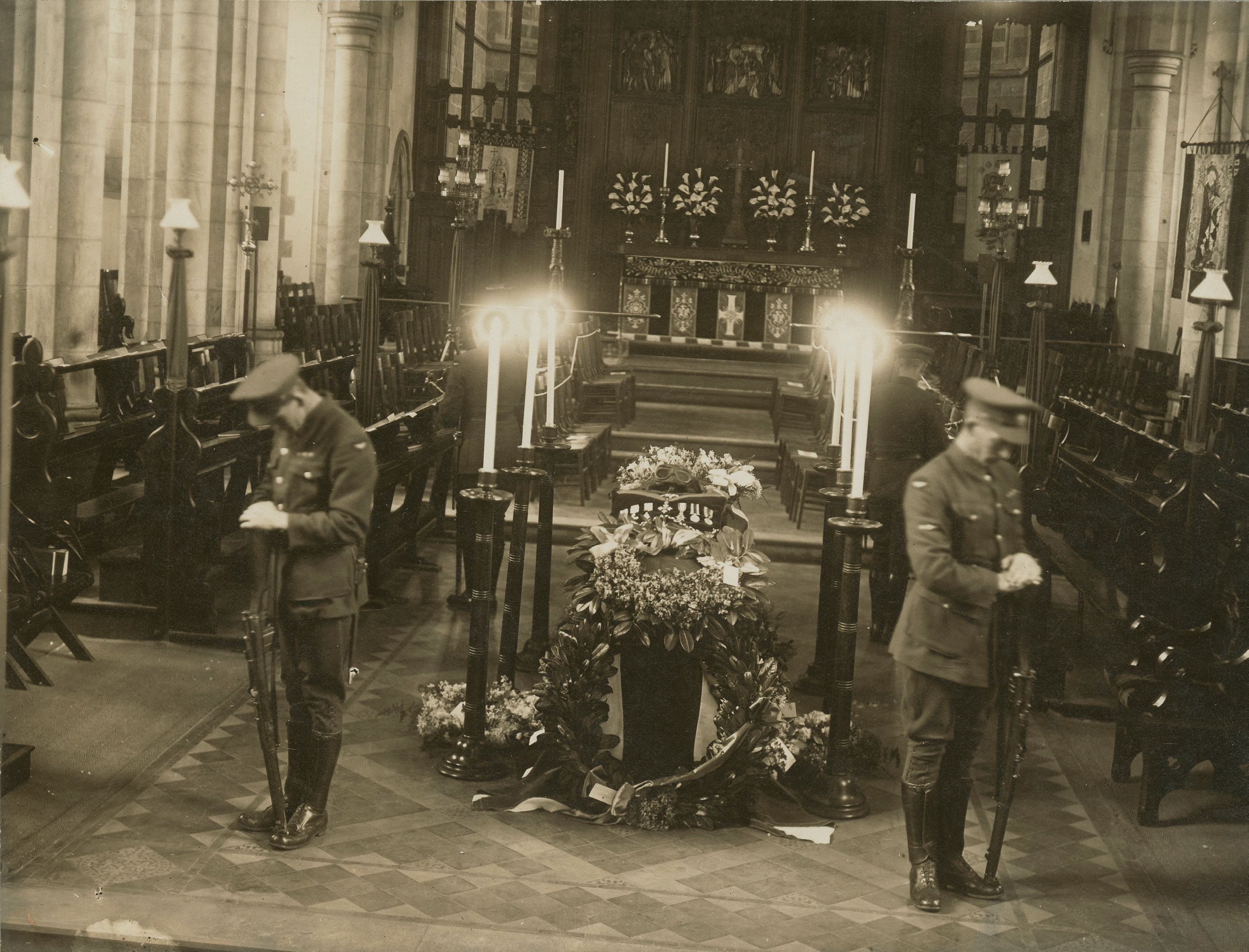 Catafalque guard LAC Richards, ACI Story, ACI Wood and ACI Hawks at the garlanded casket above the chancel steps in the sanctuary. SLSA: SRG 94/A1/71/26