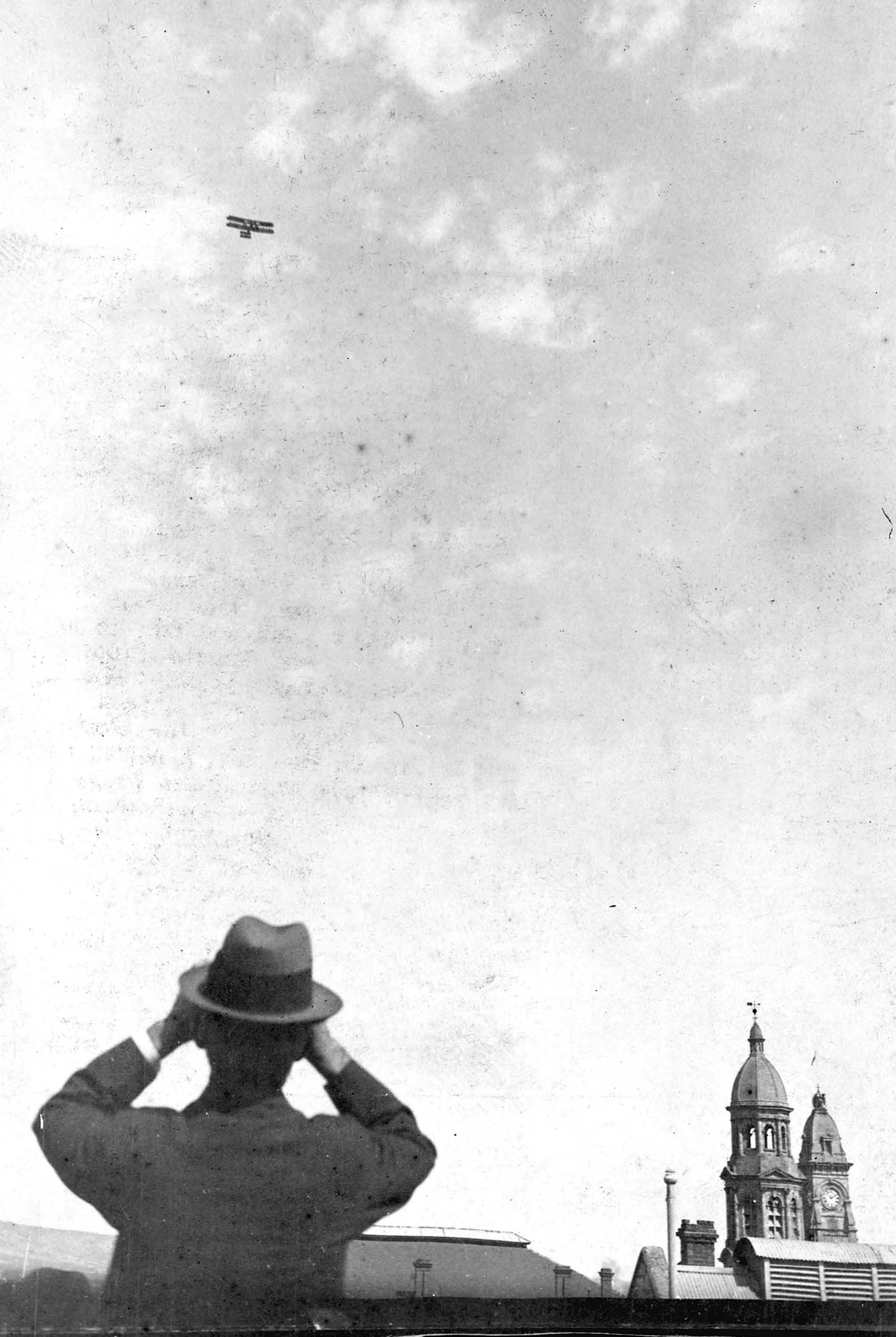 The Governor, Sir Henry Galway watches the Vickers Vimy flying over the towers of the Adelaide Town Hall and the GPOon 23 March at 1.55pm when cannons were fired. SLSA: PRG 280/1/22/354