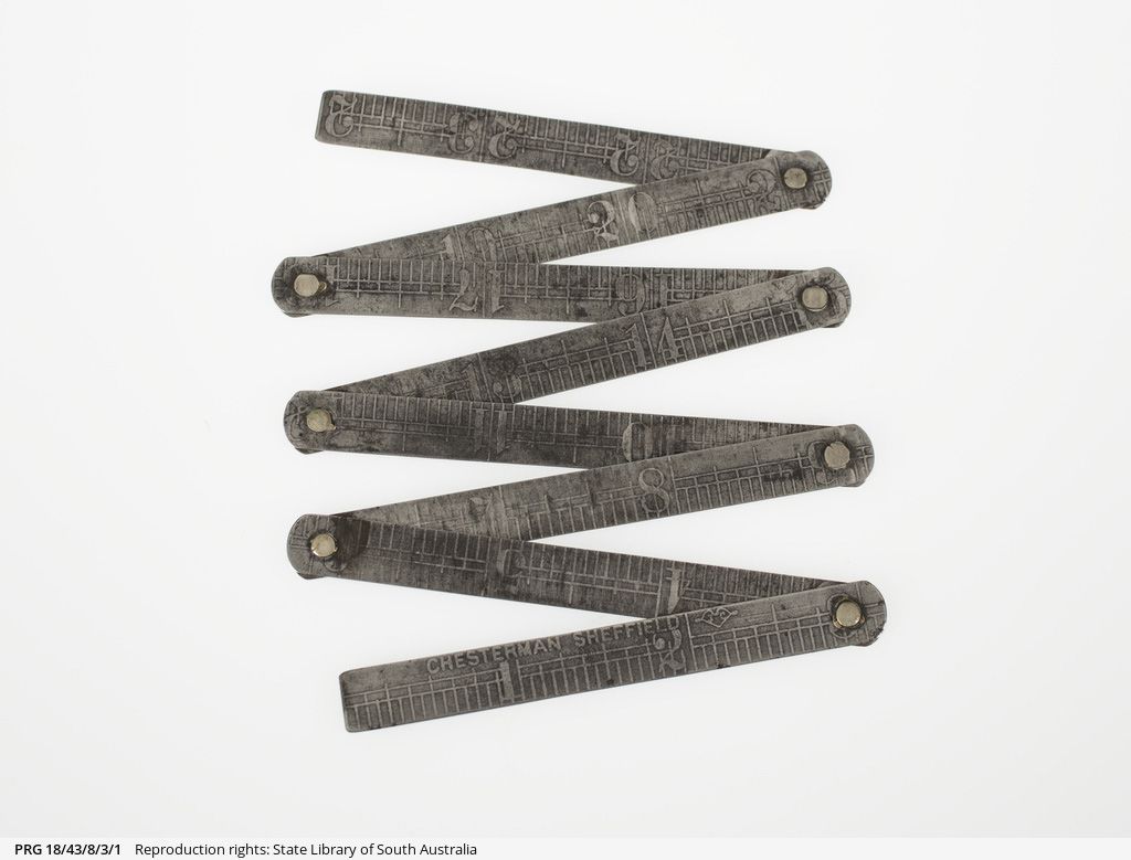 Folding steel ruler manufactured by Chesterman Sheffield (England). The metal ruler measures 21 inches long when unfolded, and consists of seven pieces each three inches long, which fold together to a compact form 3 cm x 1 cm x 0.5 cm. SLSA: PRG 18/43/8/3