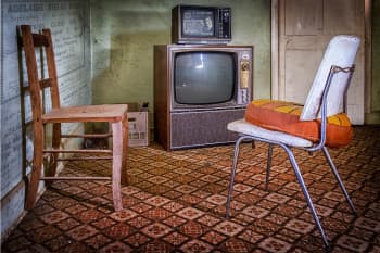 A grand day out. A living room with two chairs and an old television.