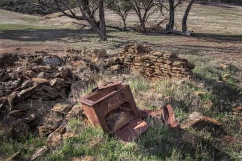 Once a home. An rusted oven sitting in a pile of bricks and rubble.