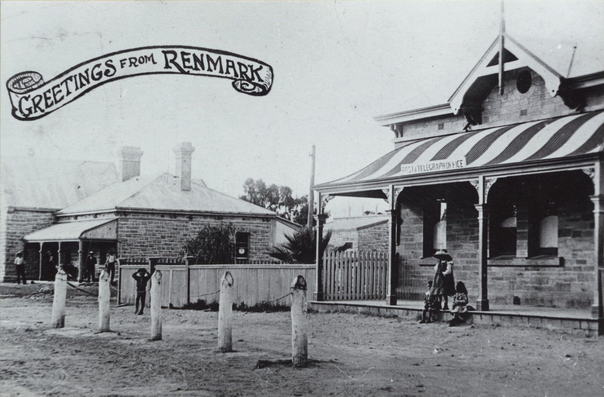 Hangin' at the 'graph. A greeting card photo of the post and telegraph office at Renmark SA, showing children sitting on the verandah of the office and standing nearby, 1904, SLSA: PRG 1258/2/2040