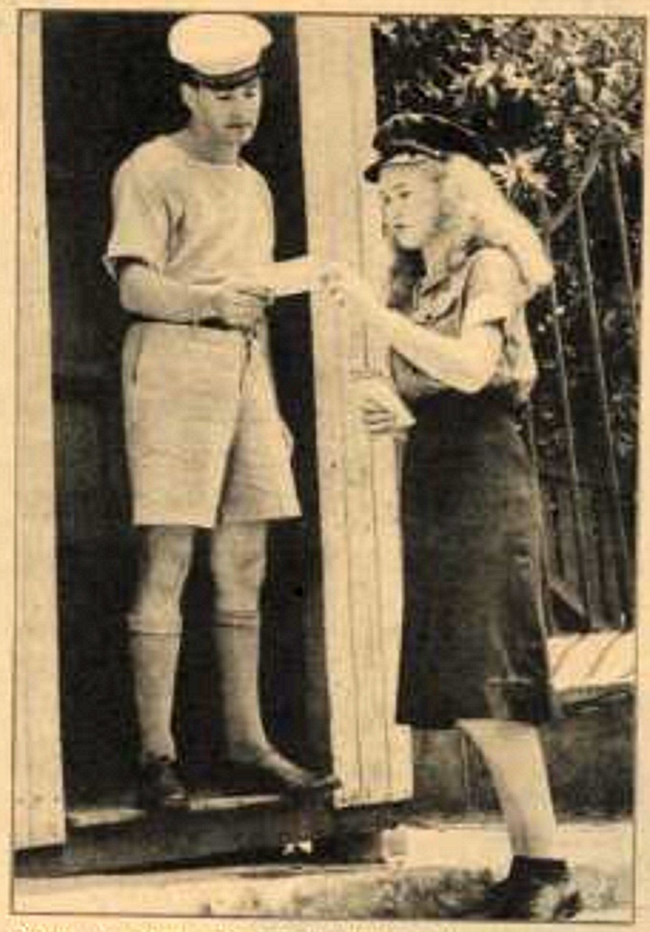 Girl messenger Sophie De Meyer delivers a telegram for a staff officer, to sentry Jim Page (HMAS Kuttabul) at the entrance to naval headquarters near Garden Island (Sydney). Pix 19 Feb 1949 p19