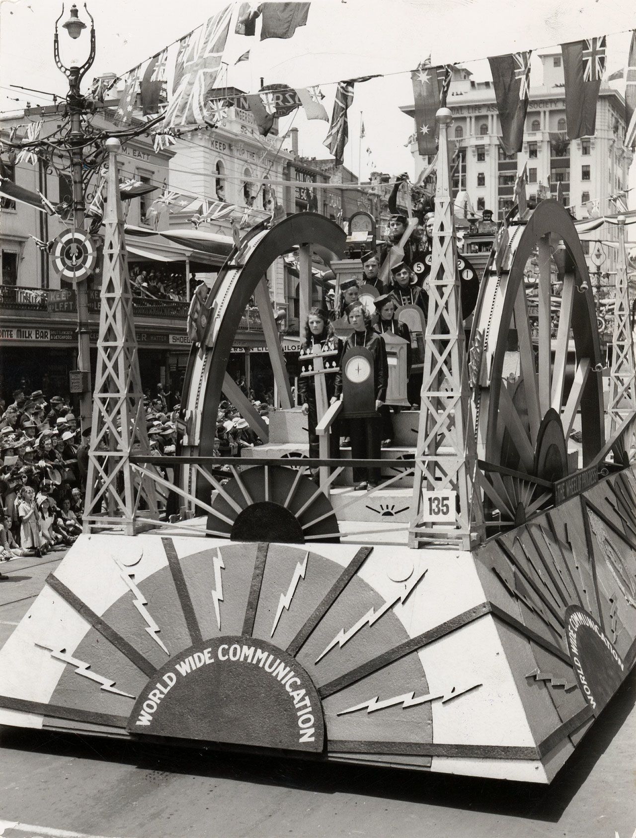 Children dressed as telegraph poles and other communications engineering, on the Post Office Tableau float for the Pageant of Progress parade, 1936. SLSA: B 8334/91