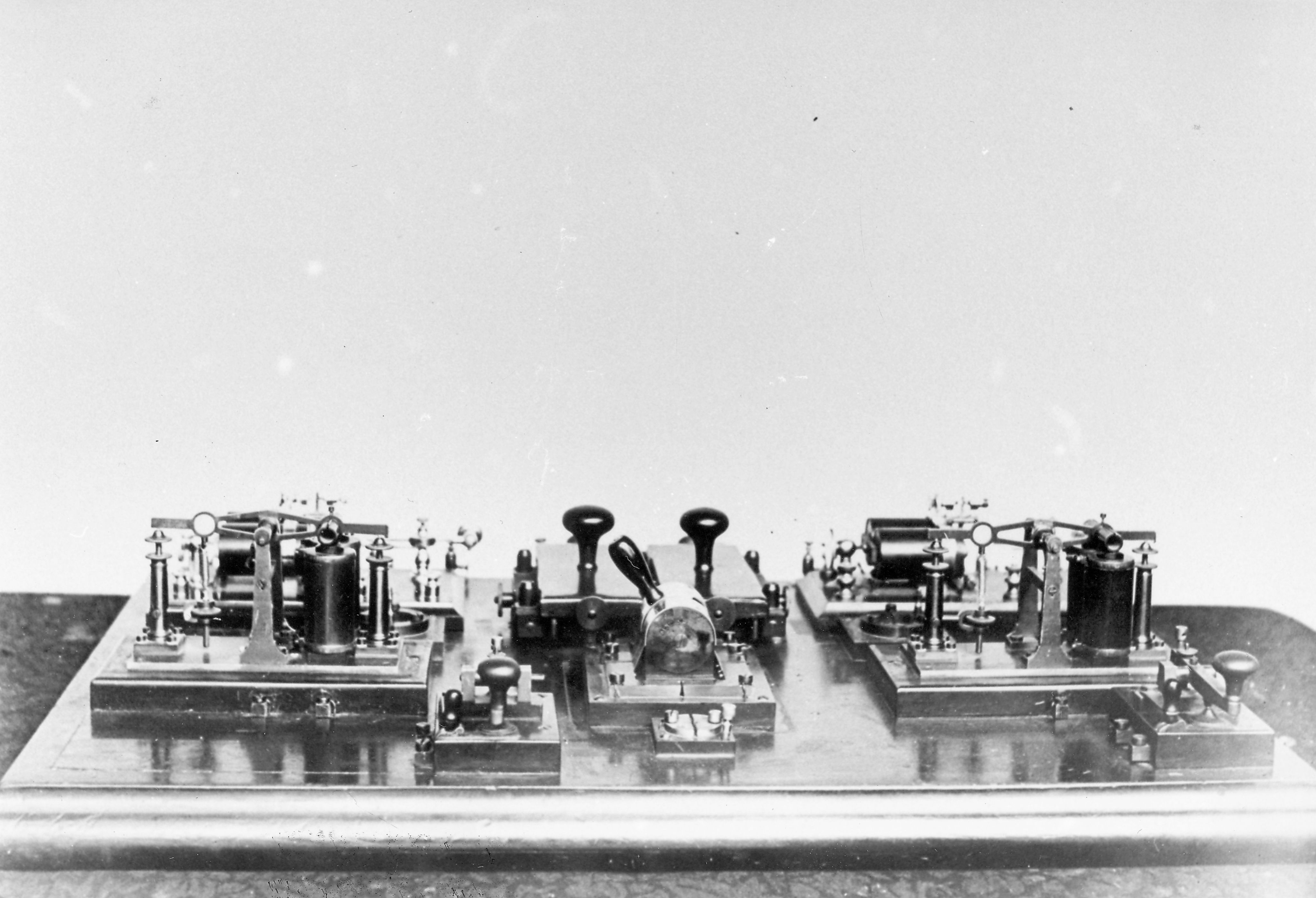 A beautiful shiny set of the telegraphy equipment used in a telegraph station, possibly at Alice Springs, 1895. SLSA: B 61453