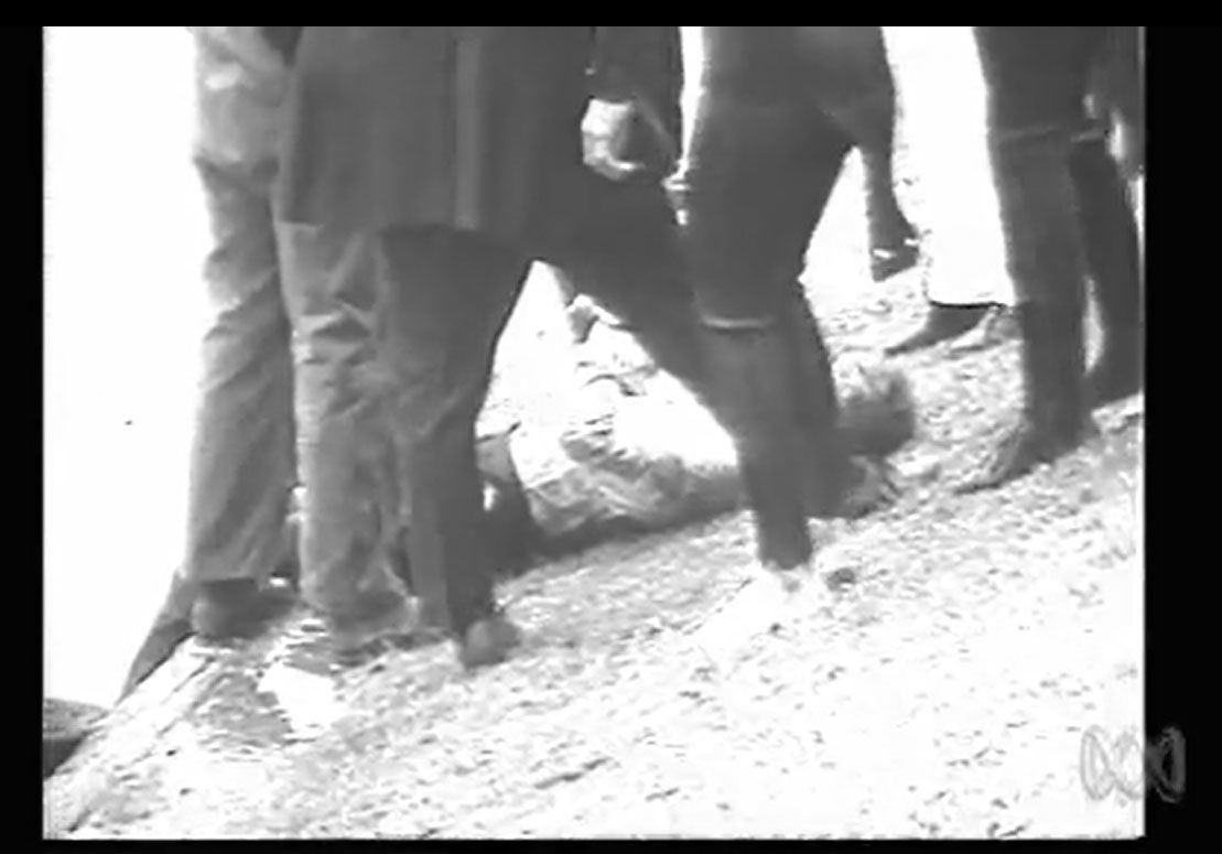 Dr Duncan's body lying on the Torrens riverbank. Screen capture, This Day Tonight. ABC, 19 July 1972