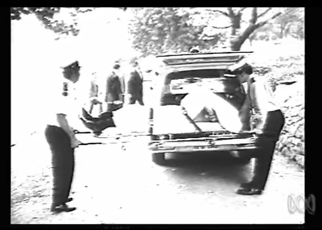 Dr Duncan's body being placed in an ambulance. Screen capture, This Day Tonight. ABC, 19 July 1972