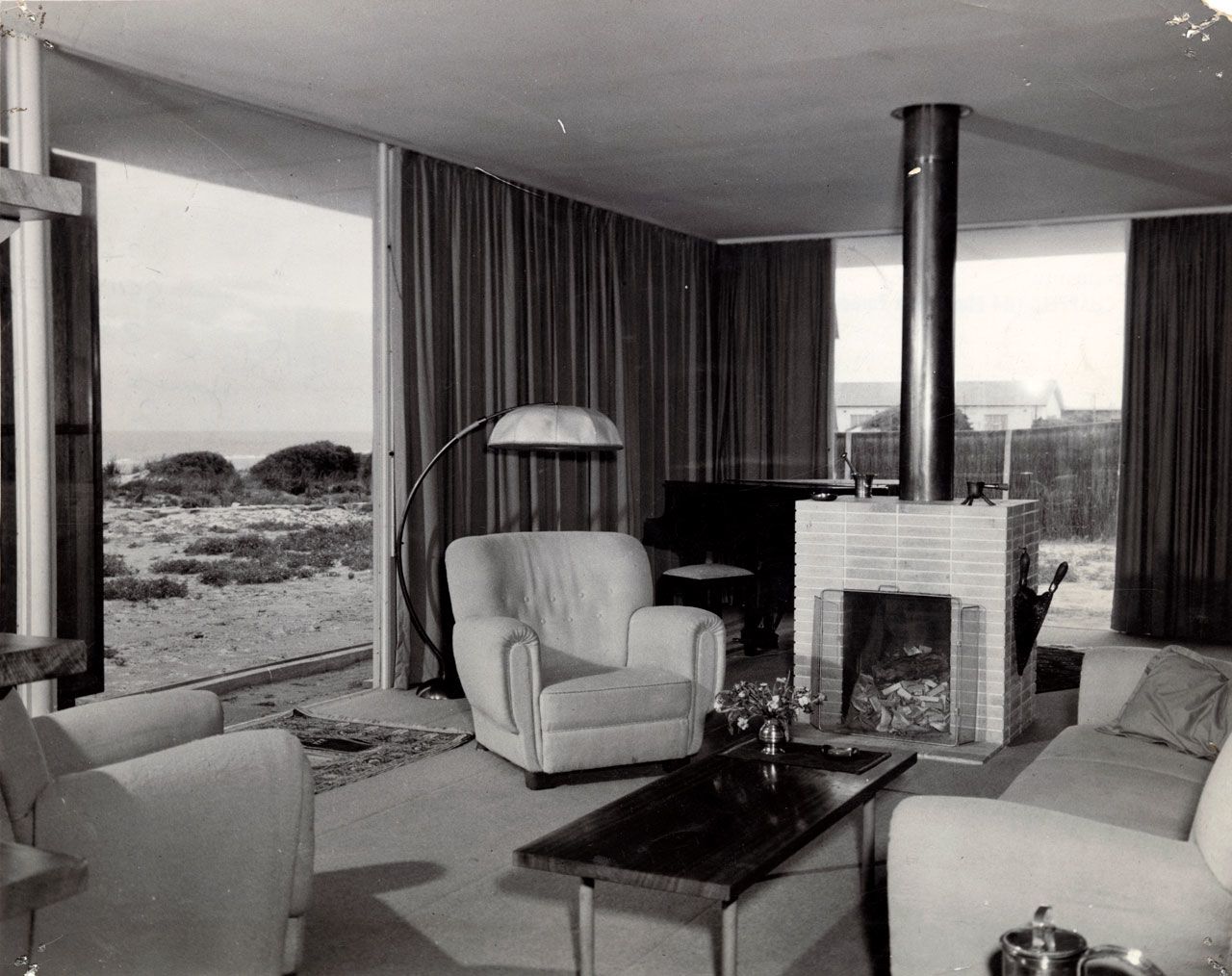 Interior view of living area, featuring views of the sand dunes and ocean, of house at Seaview Road, Tennyson. SLSA: BRG 346/28/CheesmanandCo/10/3
