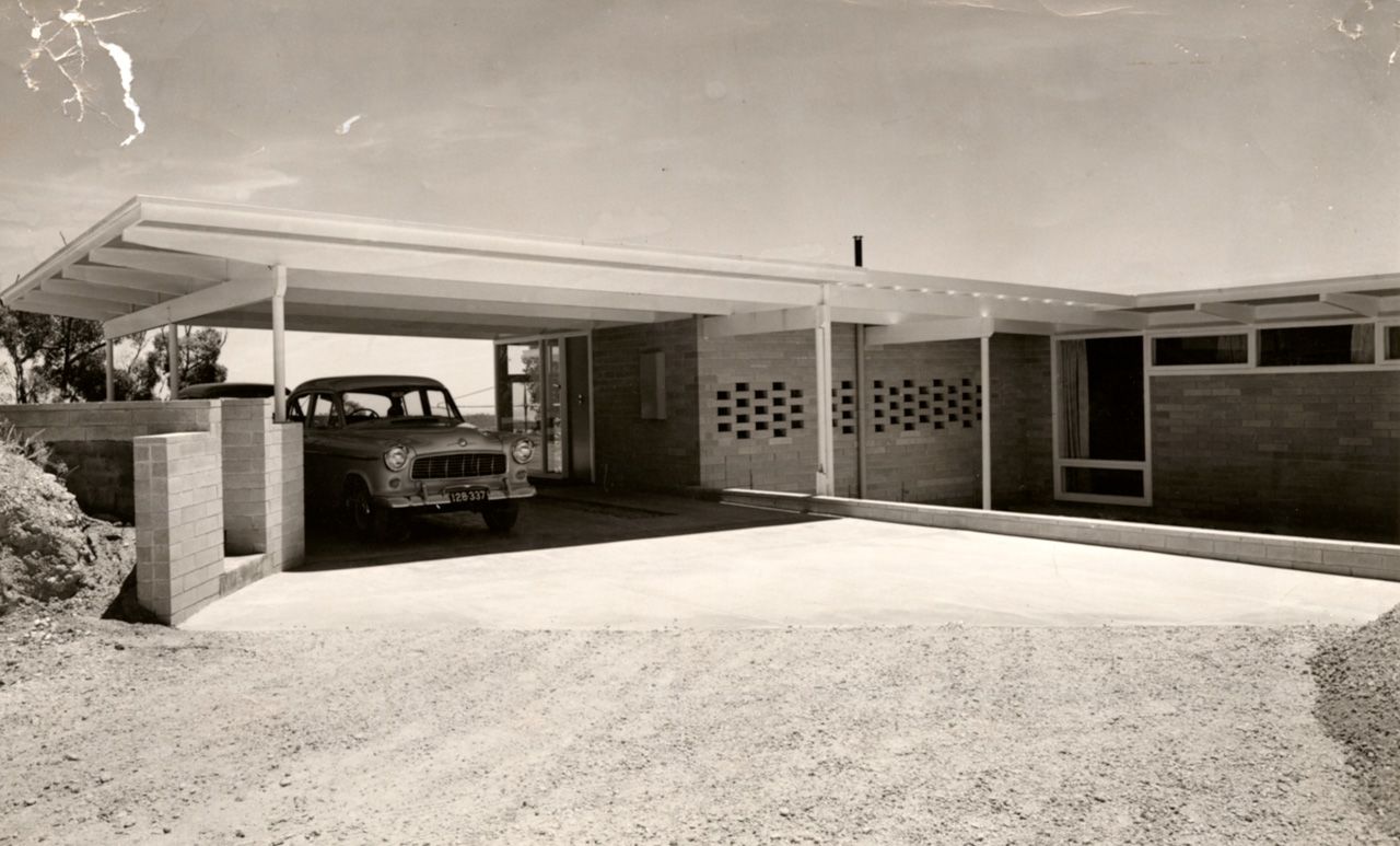 A rear view of the house and driveway with an FC Holden parked in the carport. SLSA: BRG 346/29/46/5