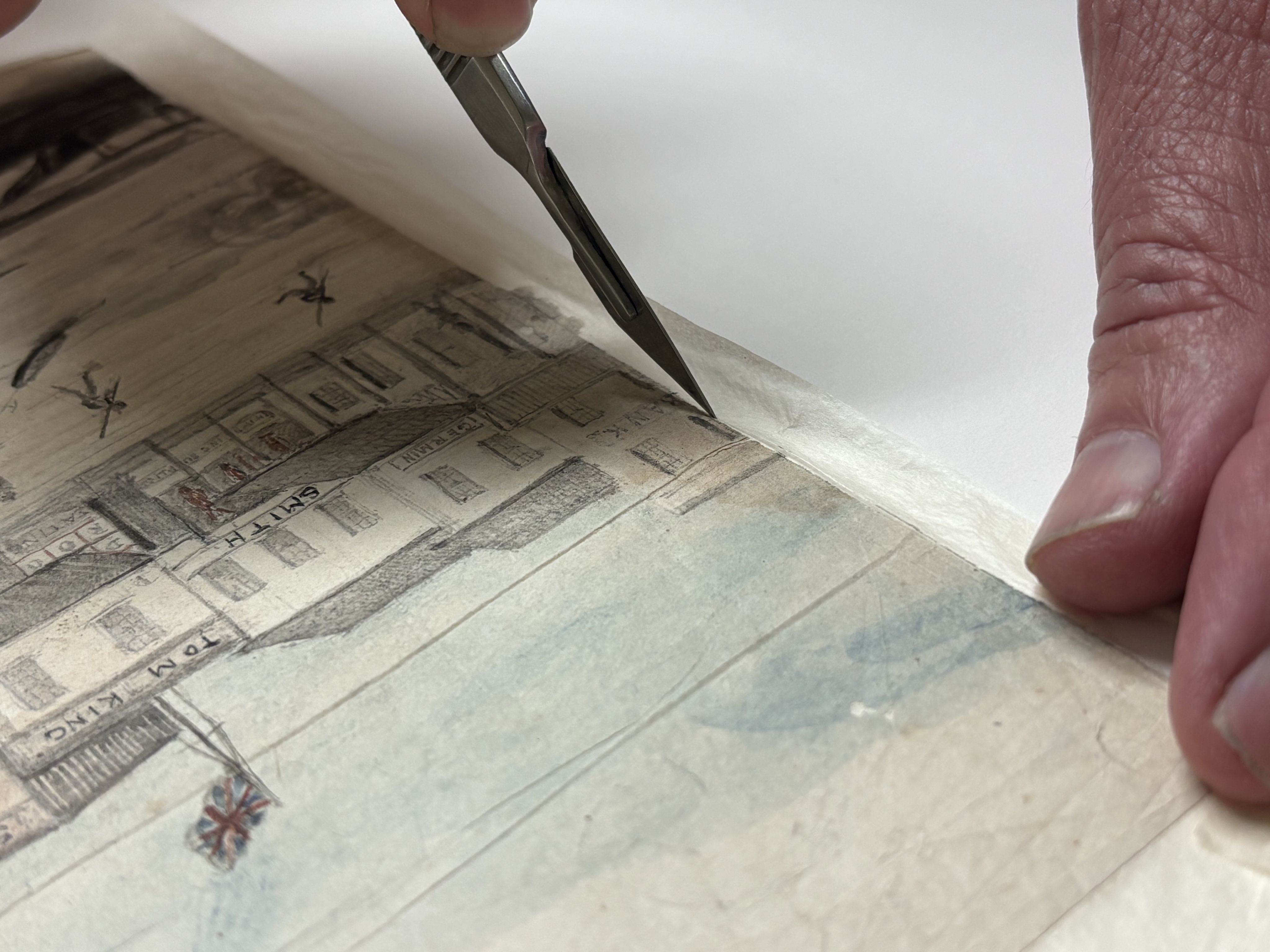 Senior Conservator, Peter Zajicek, separates the individual pages in order to correctly align the image.