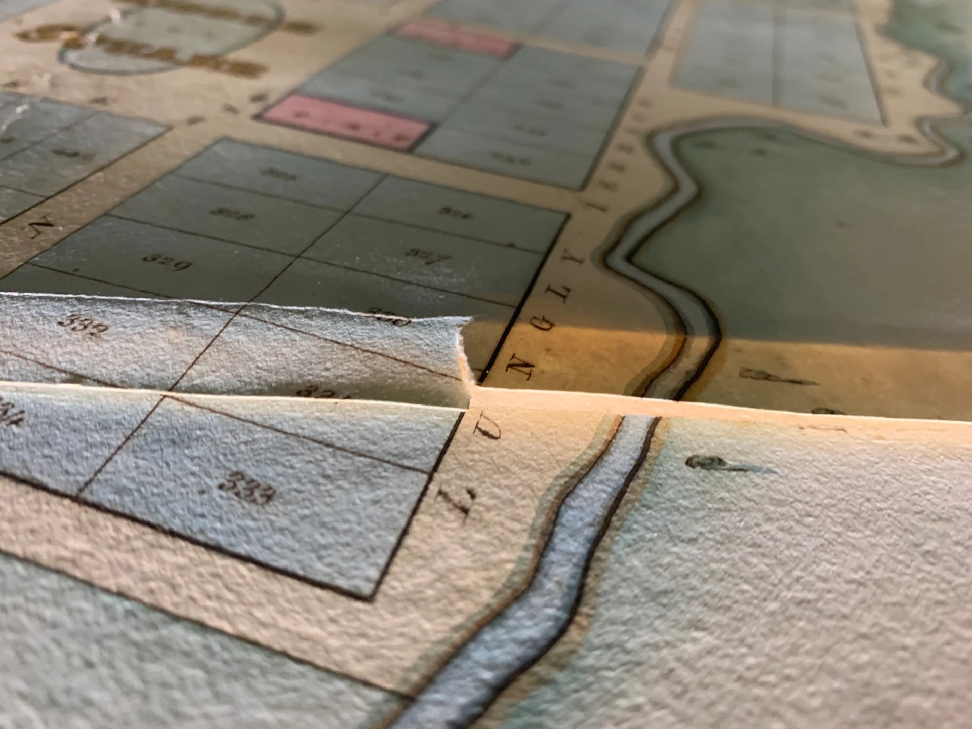 Peter working to lift the Port Gawler map from its backing, as part of the conservation treatment. SLSA: February 2023